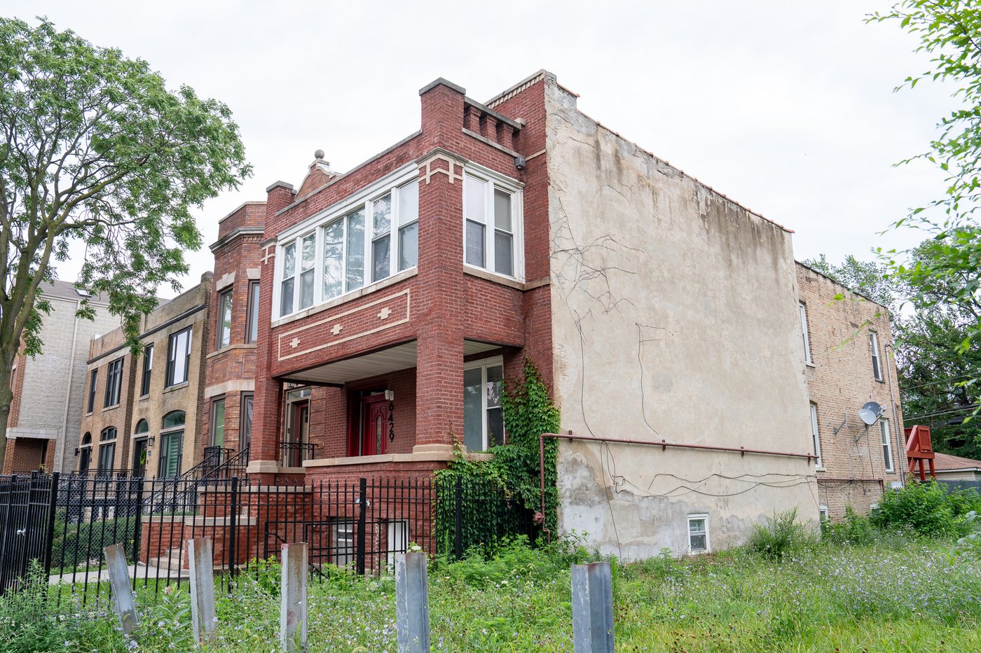 Brick two-flat with front porch and bay windows
